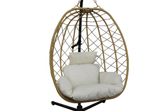 Wicker hanging chair with white cushions on a white background
