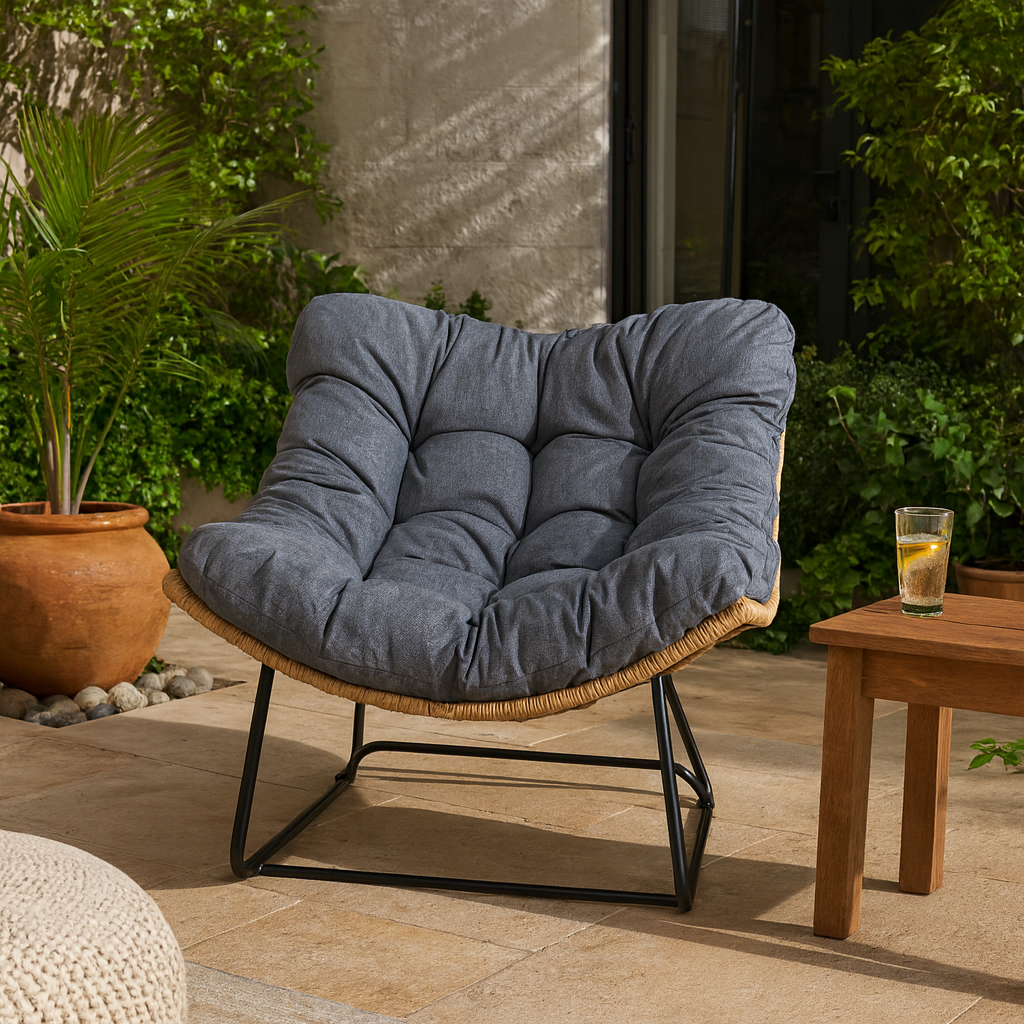 Blue cushioned chair on a patio with a glass of lemonade on a small table.