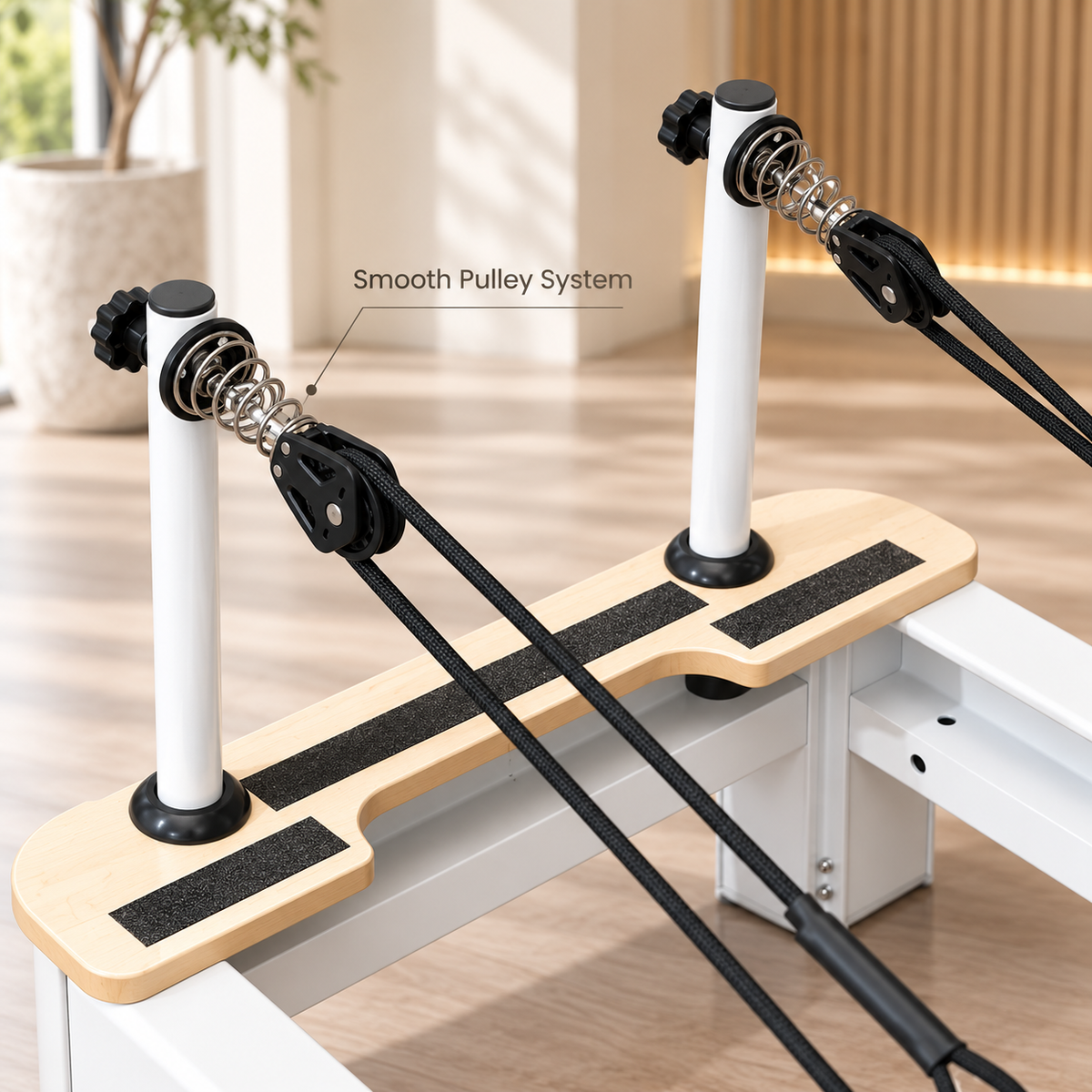 Close-up of the reformer's white rope posts, spring-loaded pulleys and wooden platform with anti-slip strips
