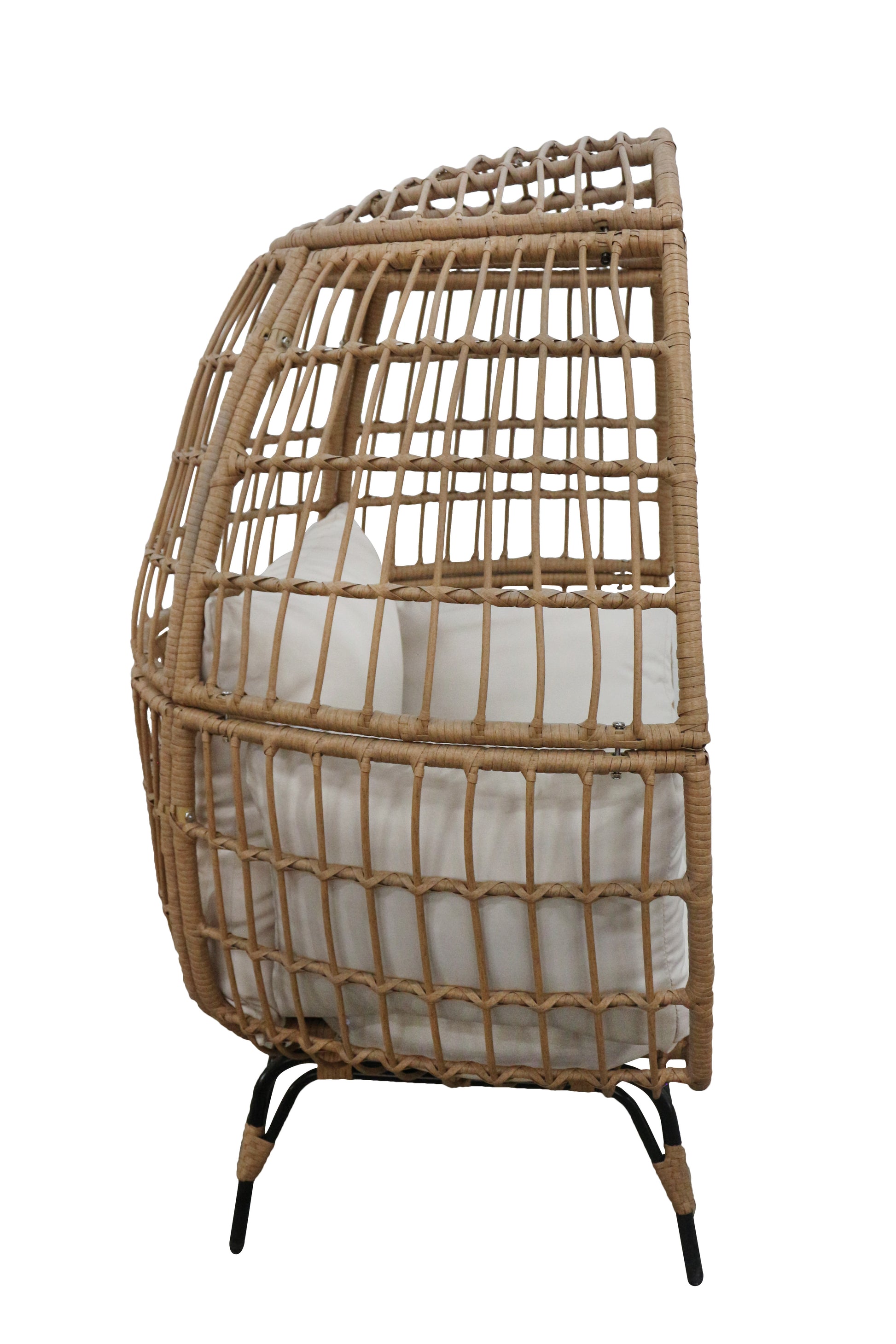 Wicker egg-shaped chair with white cushion on a white background