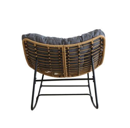 Wicker chair with a dark cushion on a white background