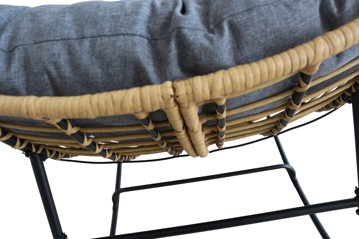 Close-up of a wicker chair with a cushion on a white background