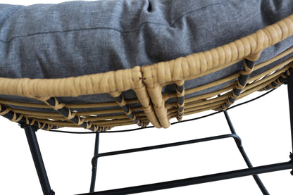 Close-up of a wicker chair with a cushion on a white background