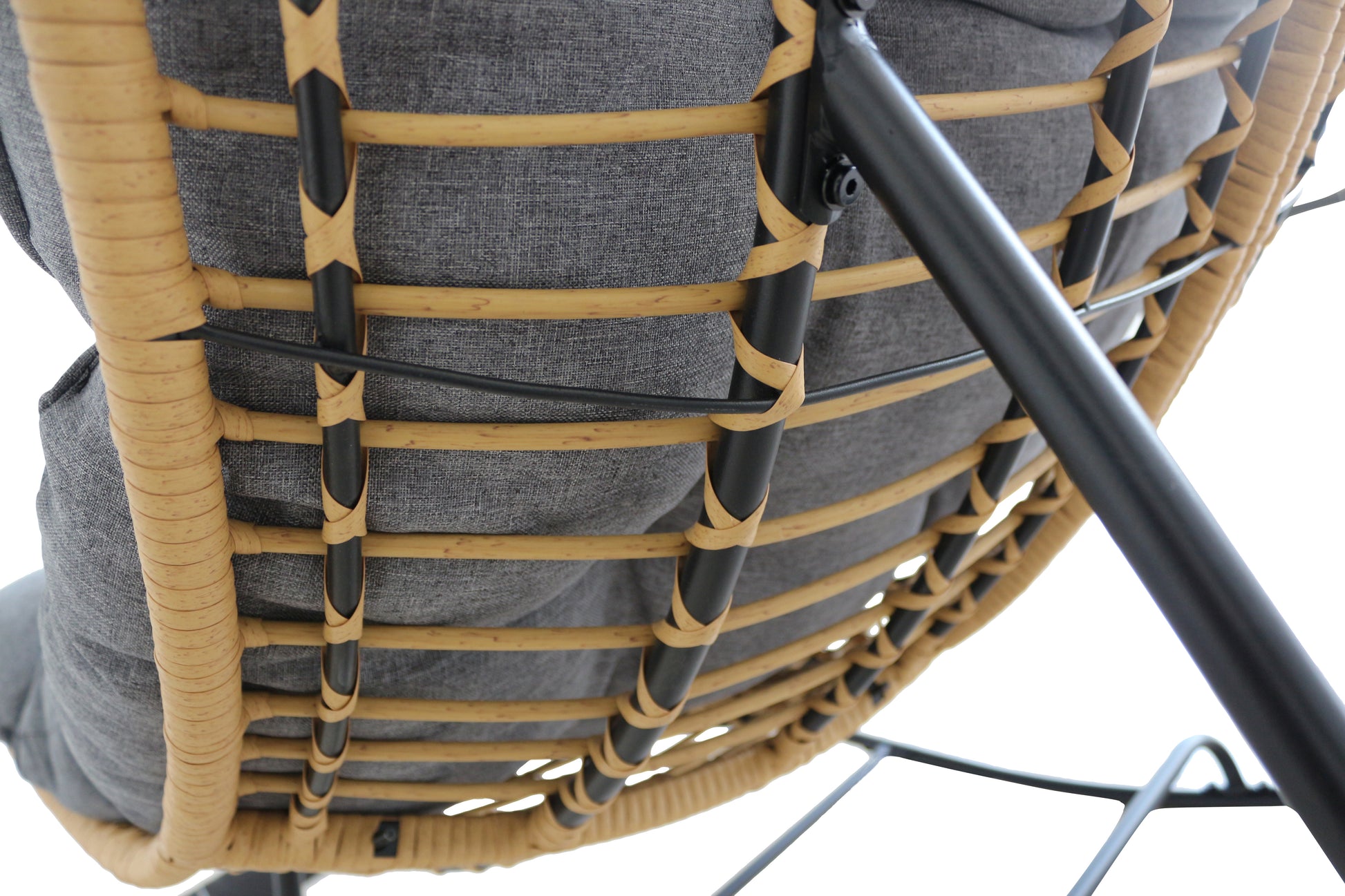 Close-up of a chair with woven backrest and gray cushion